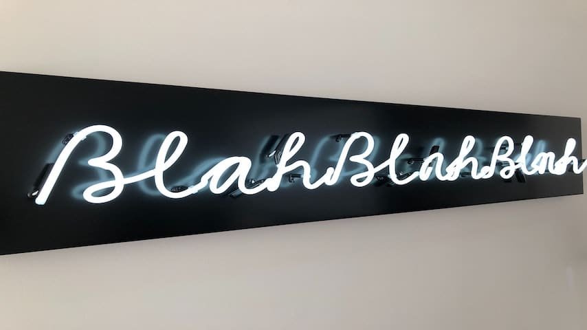 Picture illustrating 'Blahblahblah' onomatopoeia on a Neon light (black and white). For the blog Translating Onomatopoeia. Retrieved from Unsplash. https://unsplash.com/photos/pIY6sz-texg?utm_source=unsplash&utm_medium=referral&utm_content=creditShareLink