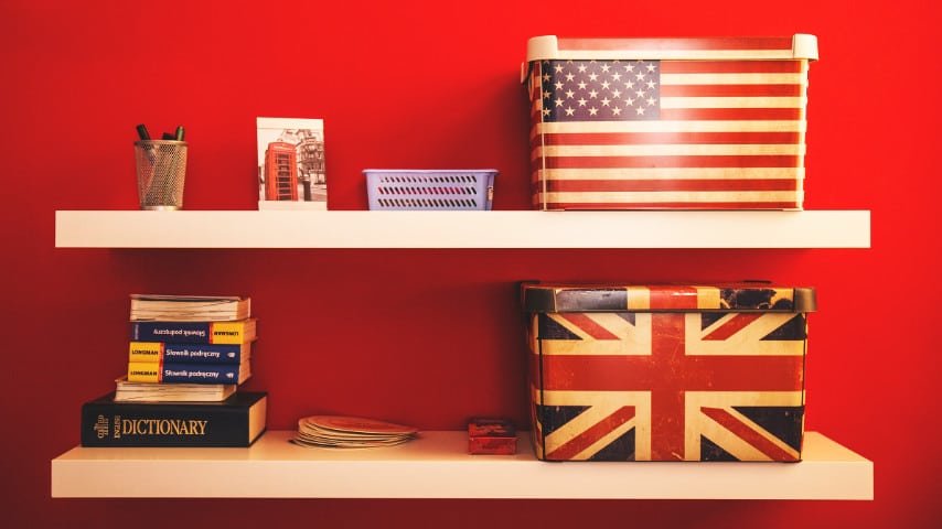 Key Difference Between American and British English. Picture of a shelf with two boxes, one with de USA flag on it and the other with de UK Flag, Picture by freestocks at Unsplash. Unplash License. https://unsplash.com/es/fotos/jUSu0686zDM