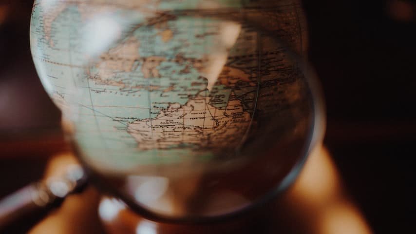Picture showing a magnifying glass looking over a globe, GoLocalise, accents, voice over