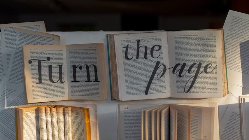 Pages of books displaying the phrase 'Turn the Page'. Translation services provided by GoLocalise.