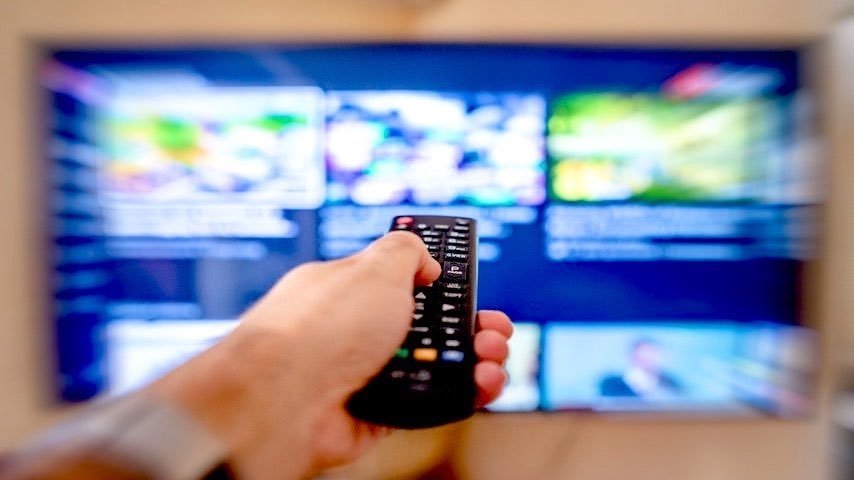 Commercials. Photo of a close up shot of a person using a tv remote control. This has been used to illustrate the article Voice-Over: The Key to Successful Commercials. Pexels licence: https://www.pexels.com/photo/a-close-up-shot-of-a-person-using-a-tv-remote-controller-12956039/