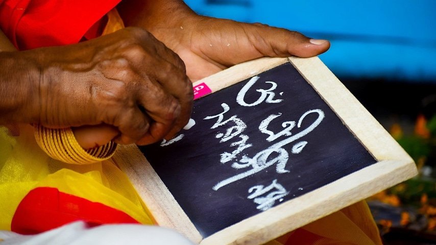 Most Spoken Indian Languages in the UK [Punjabi, Urdu, Bengali, Gujarati]. Picture of a man's hand writing at Bengali on a blackboard by Raisuvam at Pixabay. Pixabay License. https://pixabay.com/photos/bengali-hinduism-saraswatimaa-7750434/