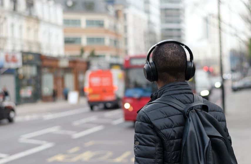 Photo of a man wearing headphones to illustrate the article “PFH Meaning for Audiobooks and Voice Over Work”.  Unsplash license: https://unsplash.com/photos/bAFiBDMeiVI