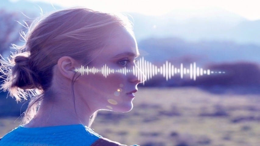 Text to Speech TTS. Photo of a young woman wearing earphones with a sound wave across the photo. FreePik: https://www.freepik.com/free-photo/hearing-issues-collage-design_33536012.htm This image is being used to illustrate the article "Text to Speech (TTS): Voiceover Evolution."