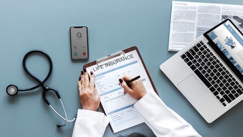 Insurance Advertisement Voice Over Script. Photo of a doctor filling up a life insurance form. This image is used to illustrate the article “Insurance Advertisement Voice Over Script Samples.” Freepik license: https://www.freepik.com/free-photo/doctor-filling-up-life-insurance-form_2825697.htm